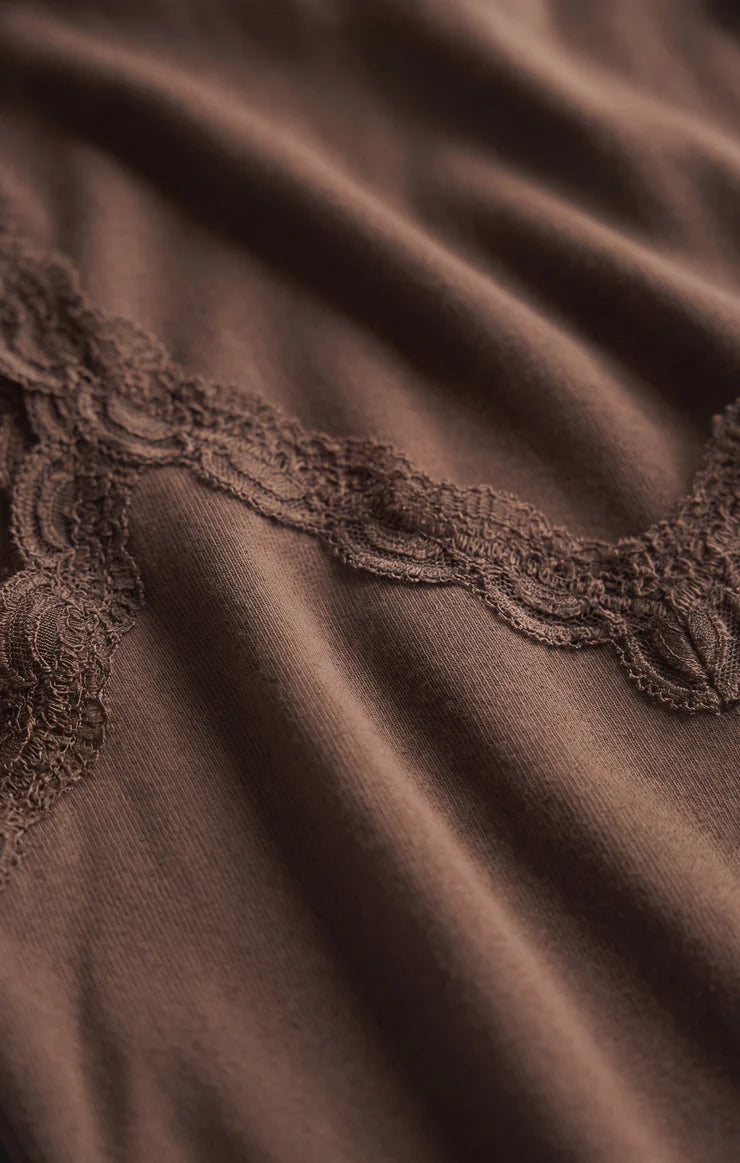 Fitted baby rib cotton tank with a lace-trimmed V-neckline and wide straps. A soft, feminine essential that's perfect for layering or wearing on its own.