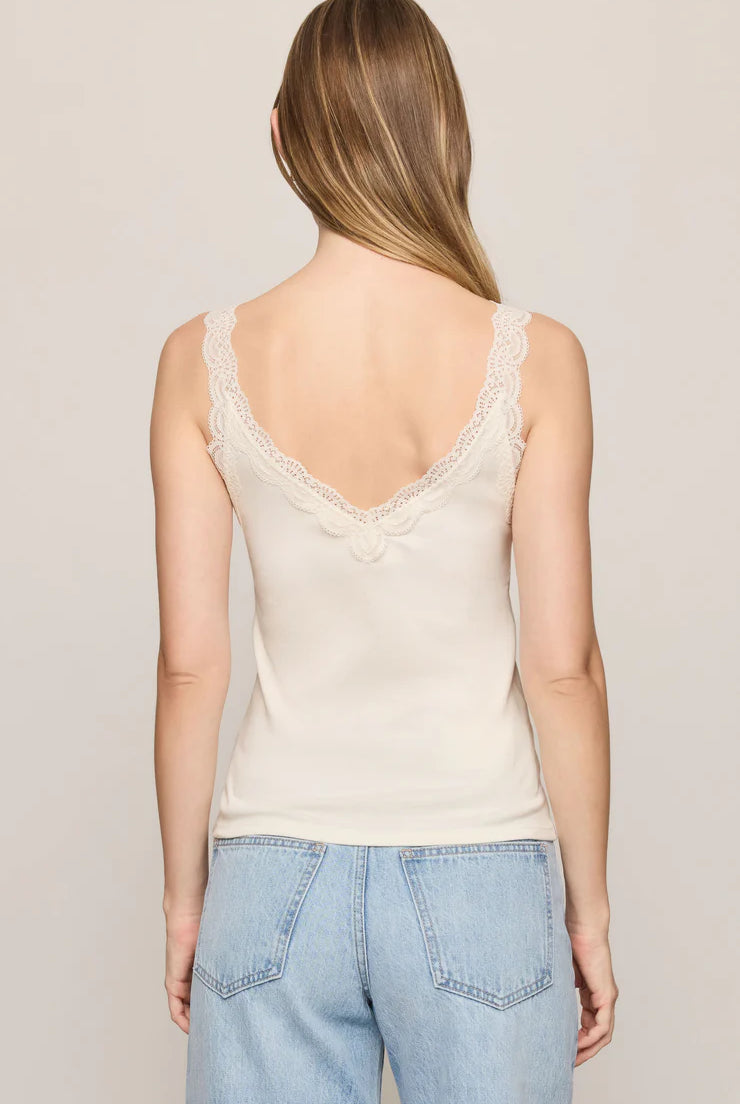 Fitted baby rib cotton tank with a lace-trimmed V-neckline and wide straps. A soft, feminine essential that's perfect for layering or wearing on its own.
