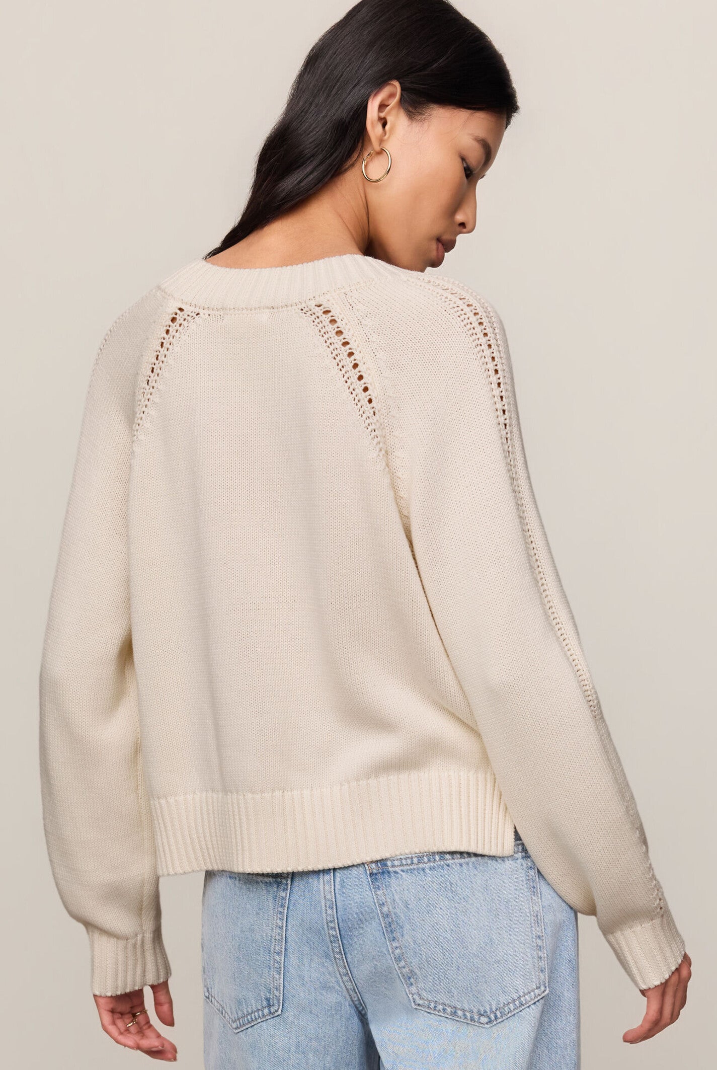 Model wearing the Z Supply Stratton V-Neck Sweater in Sandstone, featuring a V-neckline, long sleeves, and a soft cotton knit in a neutral beige hue.