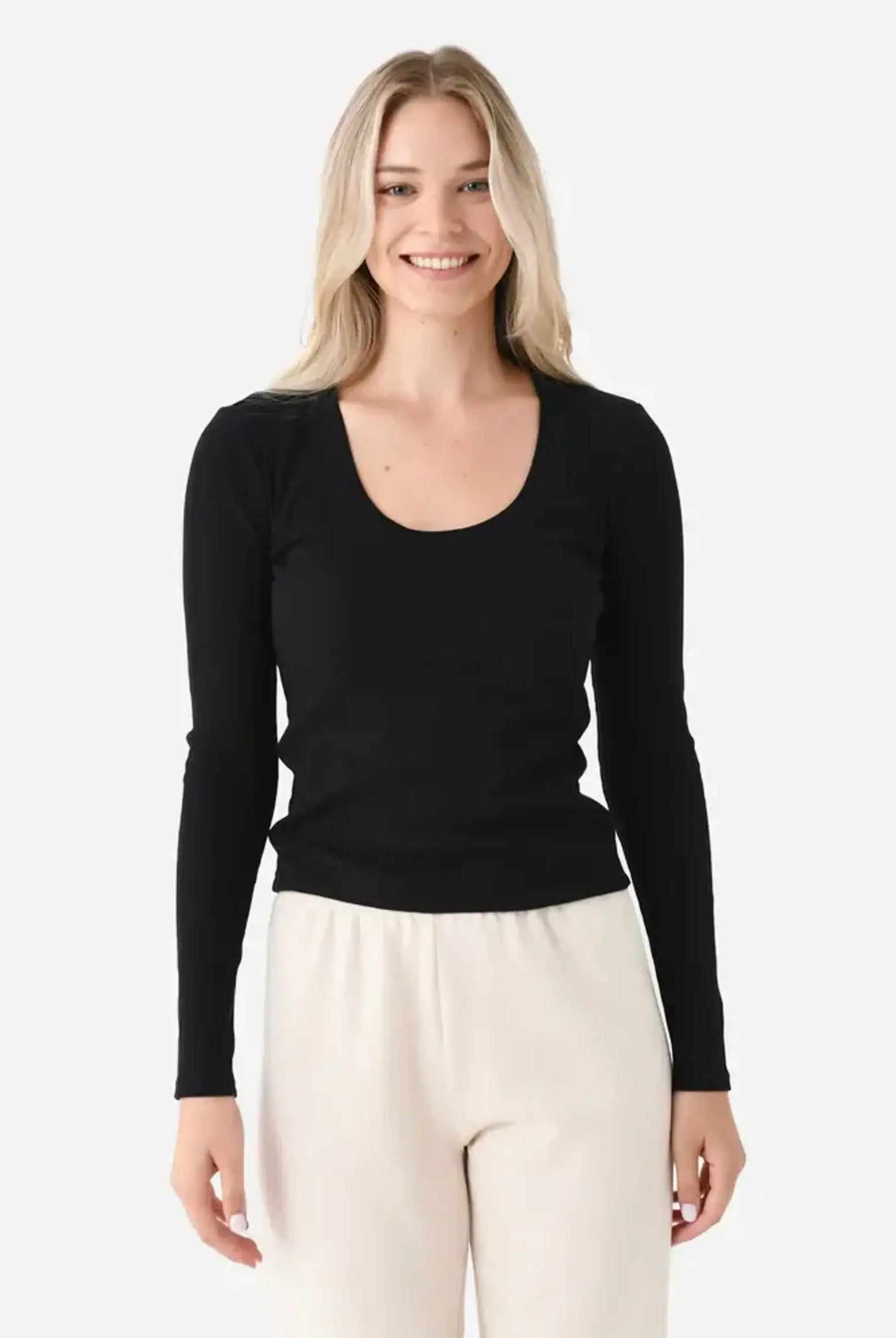 Model wearing the Z Supply Greyson Scoop Long Sleeve featuring a fitted rib knit design with a scoop neckline and long sleeves