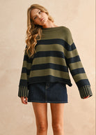 Woman wearing a striped sweater and denim skirt against a beige background