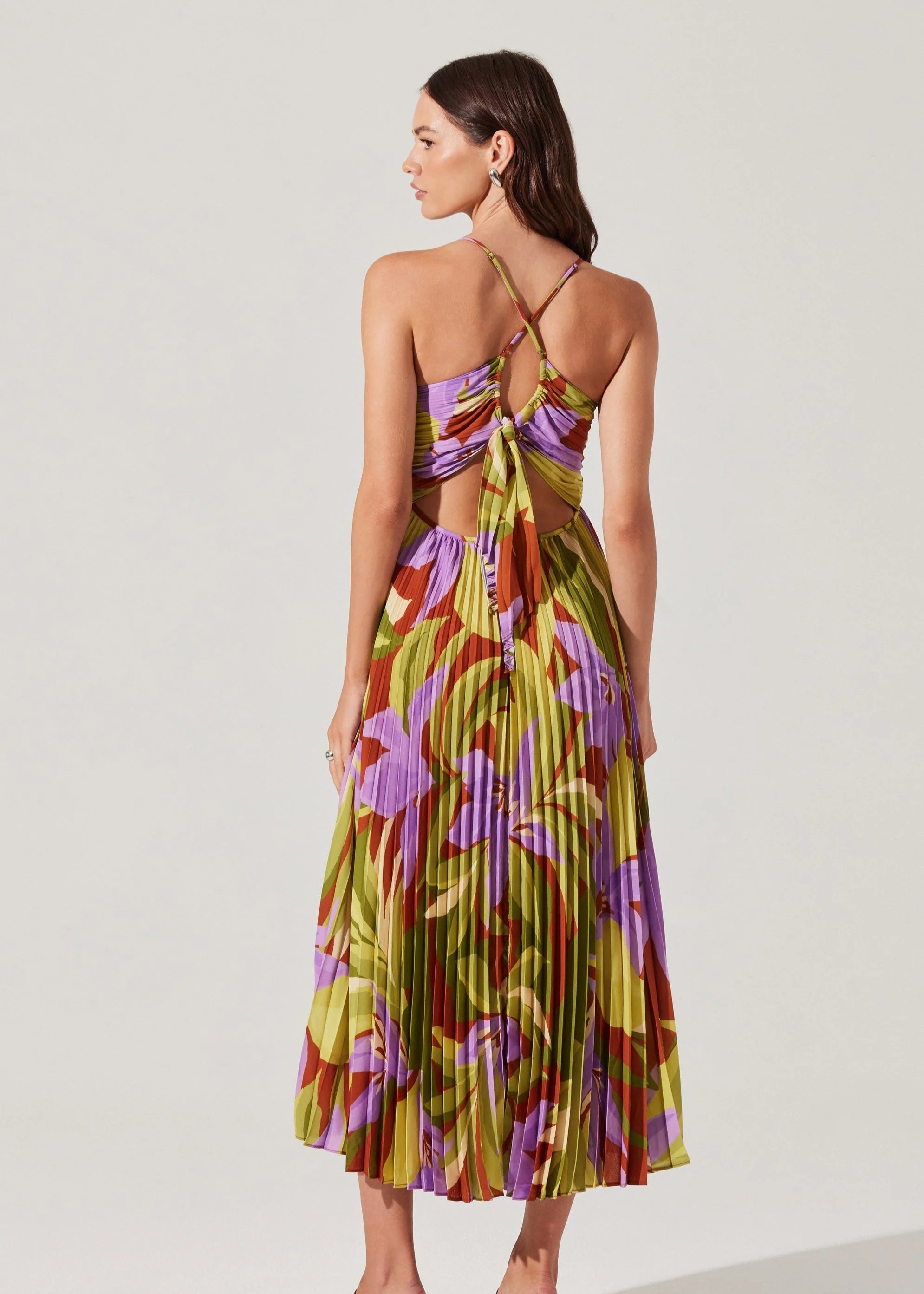 Woman wearing a colorful floral dress on a white background