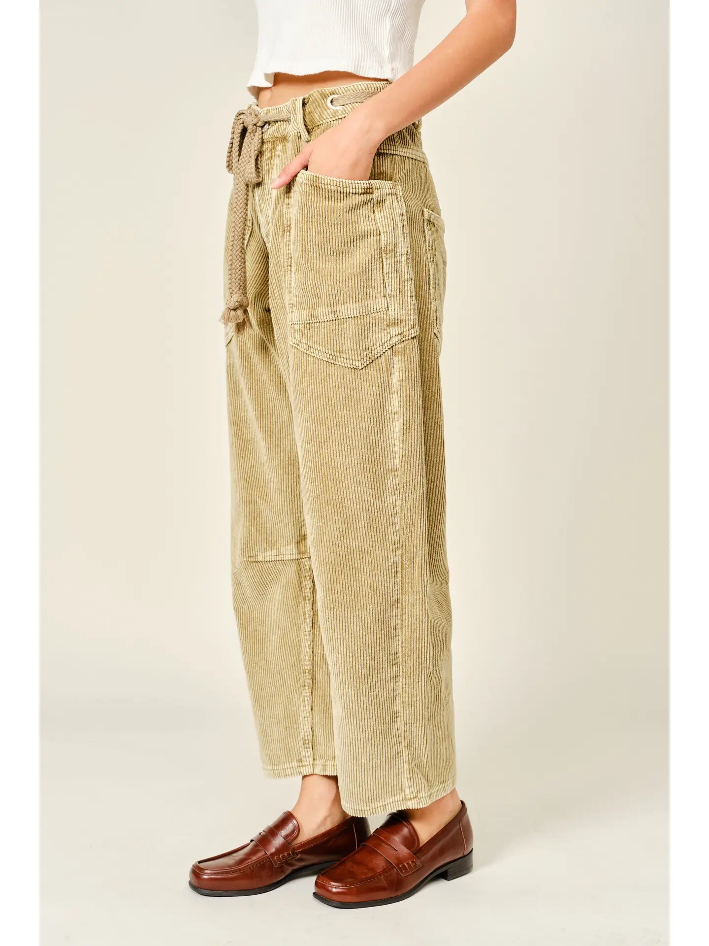 Women’s camel corduroy trousers featuring a subtle barrel fit, utility patch pockets, belt loops, and a rope tie waist.