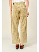 Women’s camel corduroy trousers featuring a subtle barrel fit, utility patch pockets, belt loops, and a rope tie waist.