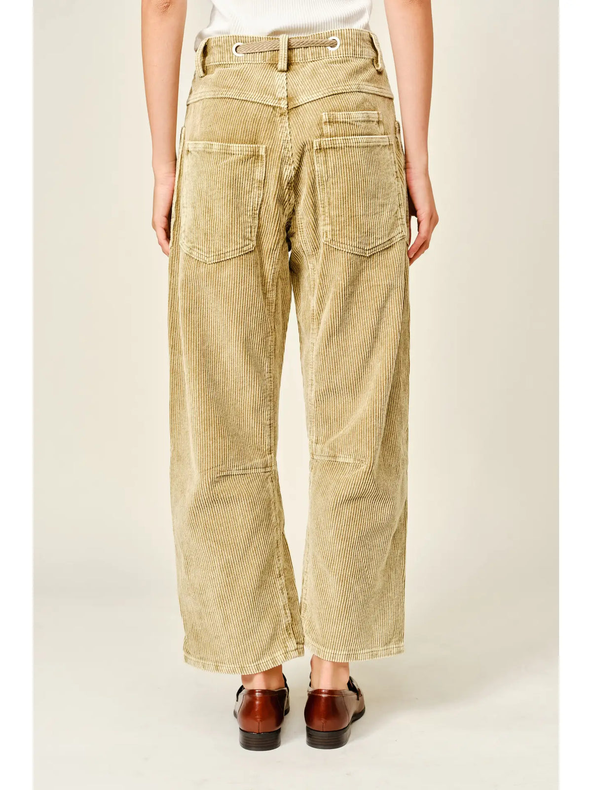 Women’s camel corduroy trousers featuring a subtle barrel fit, utility patch pockets, belt loops, and a rope tie waist.