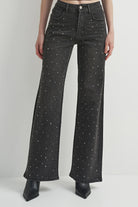 Washed black denim jeans with a flattering leg and rhinestone detailing, adding a subtle western-inspired touch.