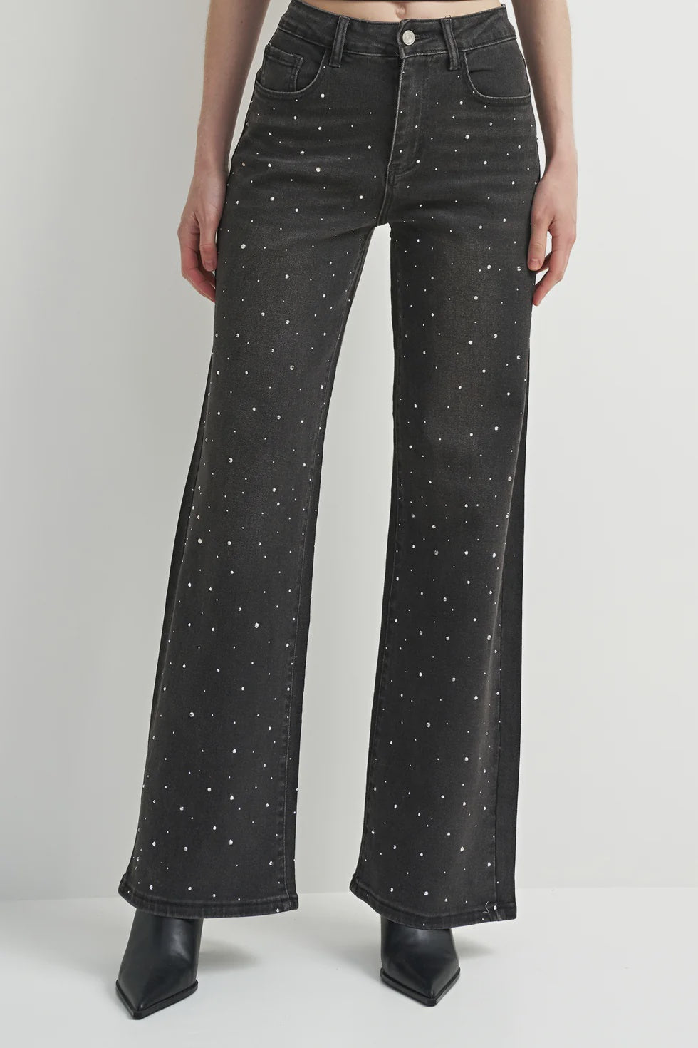Washed black denim jeans with a flattering leg and rhinestone detailing, adding a subtle western-inspired touch.