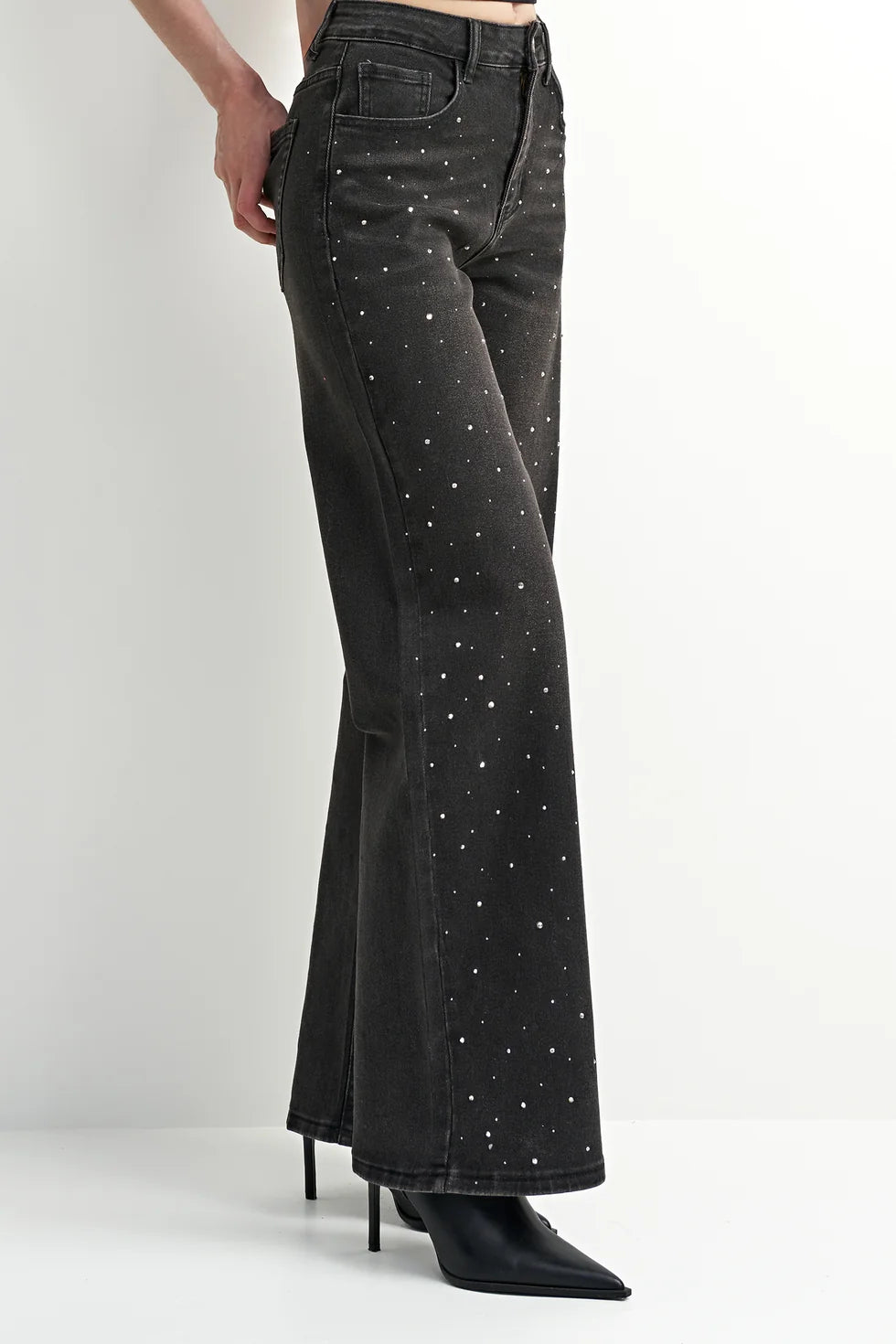 Washed black denim jeans with a flattering leg and rhinestone detailing, adding a subtle western-inspired touch.