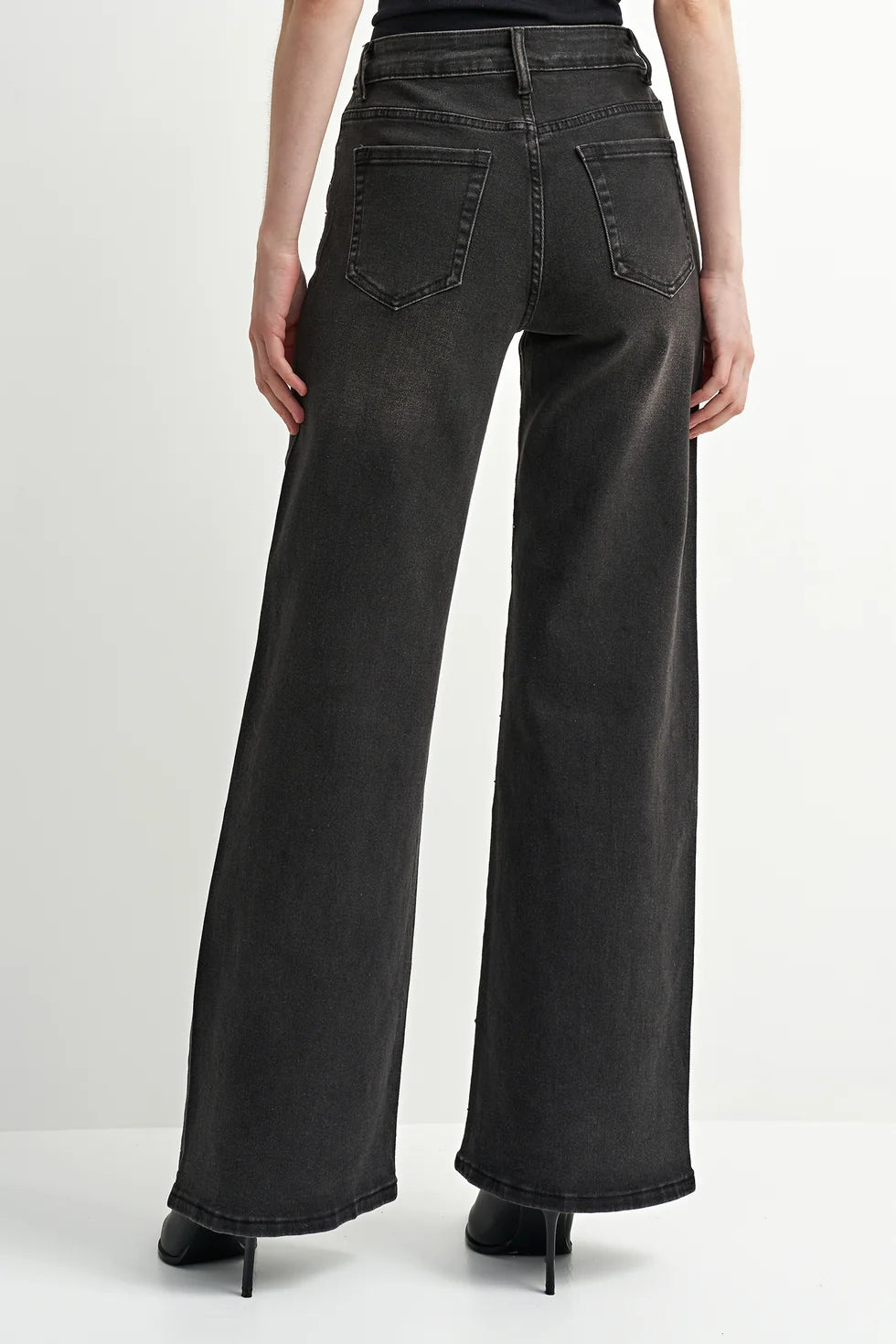 Washed black denim jeans with a flattering leg and rhinestone detailing, adding a subtle western-inspired touch.