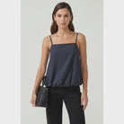 Navy bubble cami tank featuring a square neckline, adjustable spaghetti straps, a relaxed flowy silhouette, and a gathered bubble hem