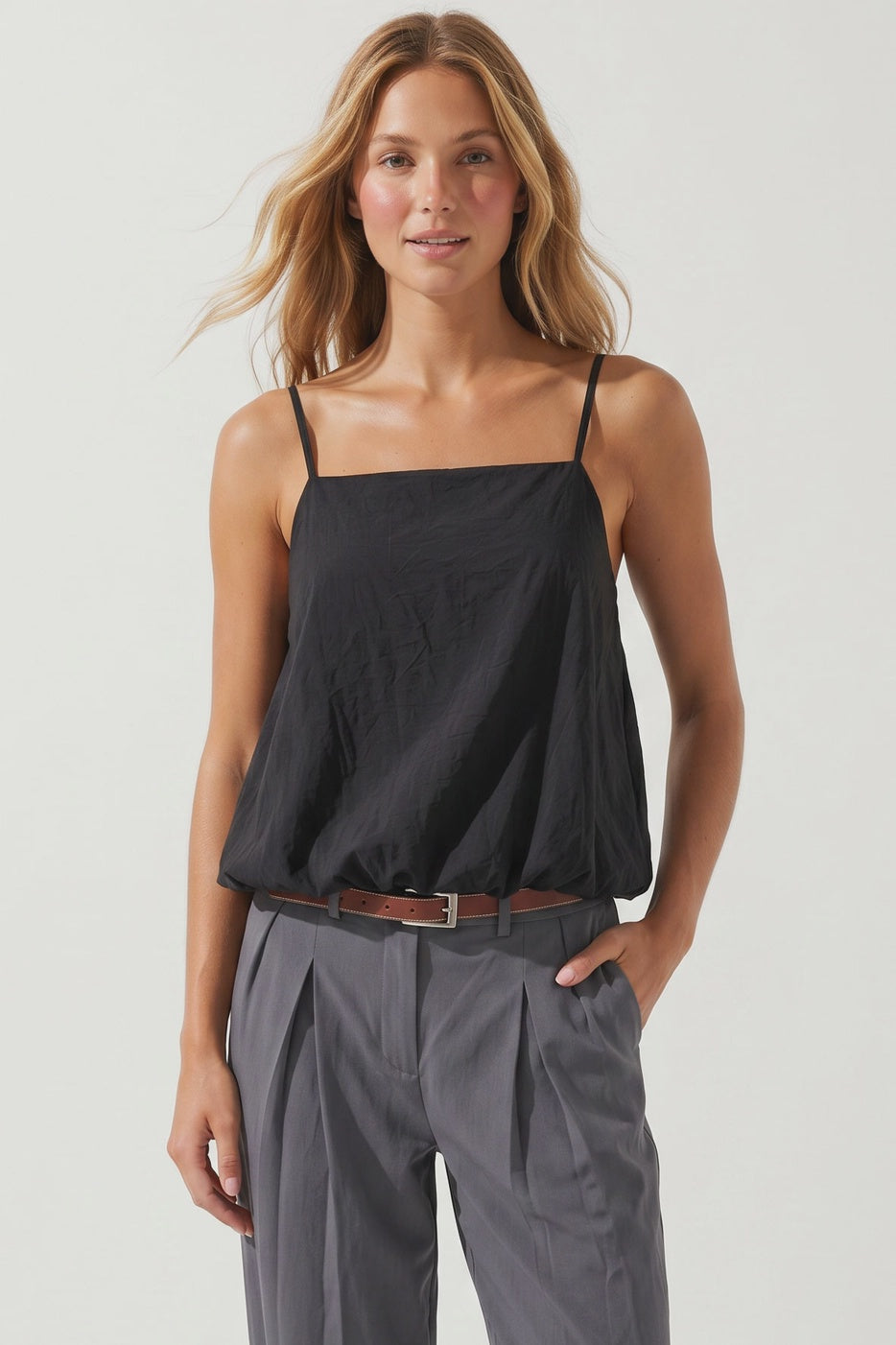 woman wearing a black bubble hem tank top