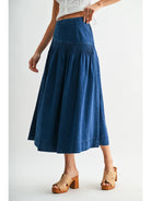 Heritage Midi Denim Skirt in classic blue denim, featuring a high-waisted fit and softly flared silhouette.
