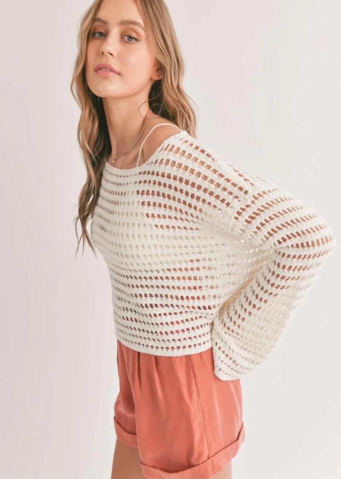 Sadie & Sage Carlita Open Knit Sweater - White. This open knit sweater is perfect for chilly days or evenings. The lightweight material keeps you comfortably warm, while the unique open knit pattern adds a touch of sophistication. The long sleeves offer both style and coverage, and the loose fit allows for unrestricted movement. A versatile piece that can be worn solo or layered, this sweater is a must-have for any fashion-forward wardrobe.
