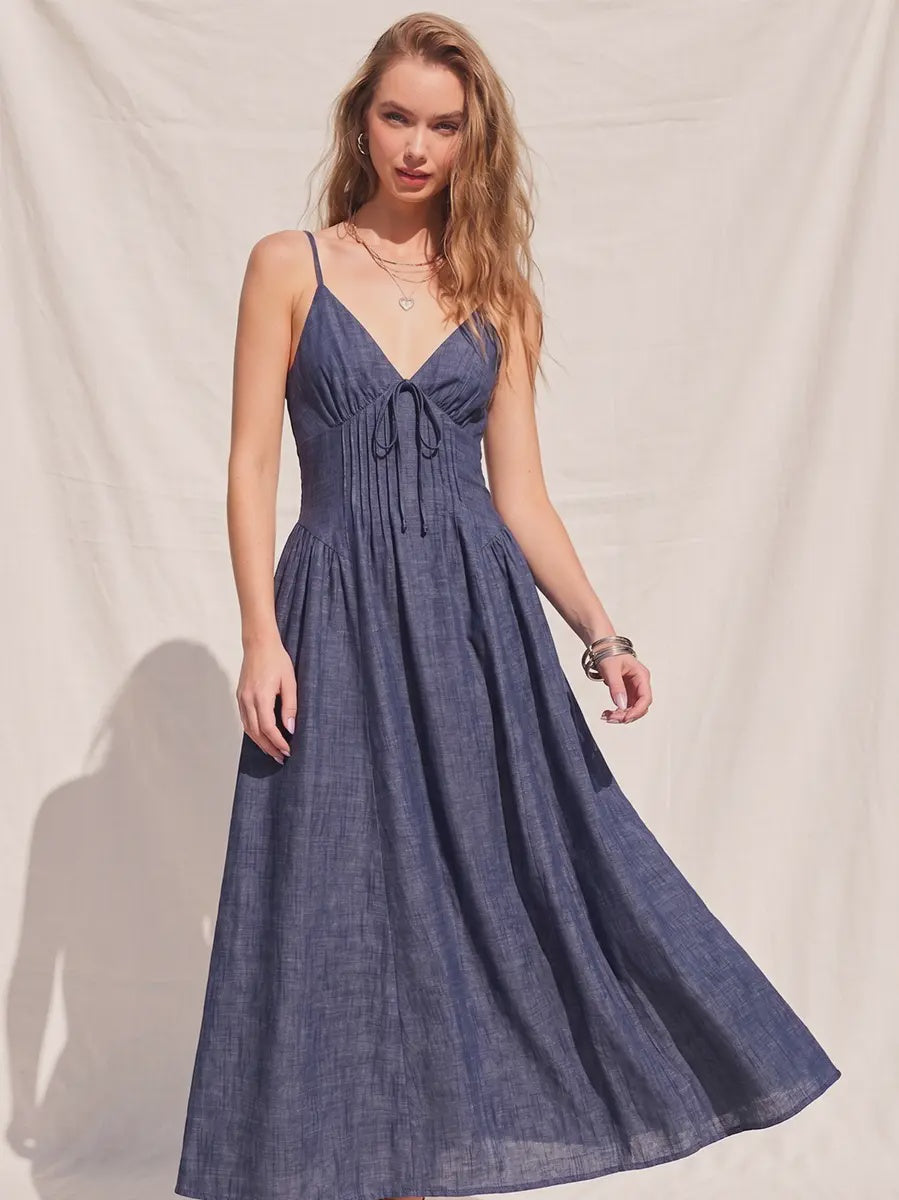 Women's denim fit-and-flare midi dress with a V-neckline, corset waist detailing, adjustable straps, a smocked back, and a flattering feminine silhouette.