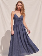Women's denim fit-and-flare midi dress with a V-neckline, corset waist detailing, adjustable straps, a smocked back, and a flattering feminine silhouette.