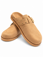 Chinese Laundry Cove Suede Clogs in Natural, featuring a natural faux-suede upper, gold-tone buckle with a rounded closed toe, open-back slip-on design, and contrasting sole.