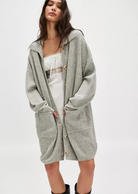 Free People Emmy Cardi.Essential to every collection of layers, this classic cardi is featured in a soft ribbed knit fabrication and slouchy silhouette with button-front closures and a collared-neckline.