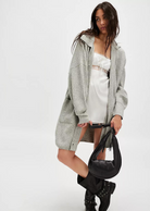 Free People Emmy Cardi.Essential to every collection of layers, this classic cardi is featured in a soft ribbed knit fabrication and slouchy silhouette with button-front closures and a collared-neckline.