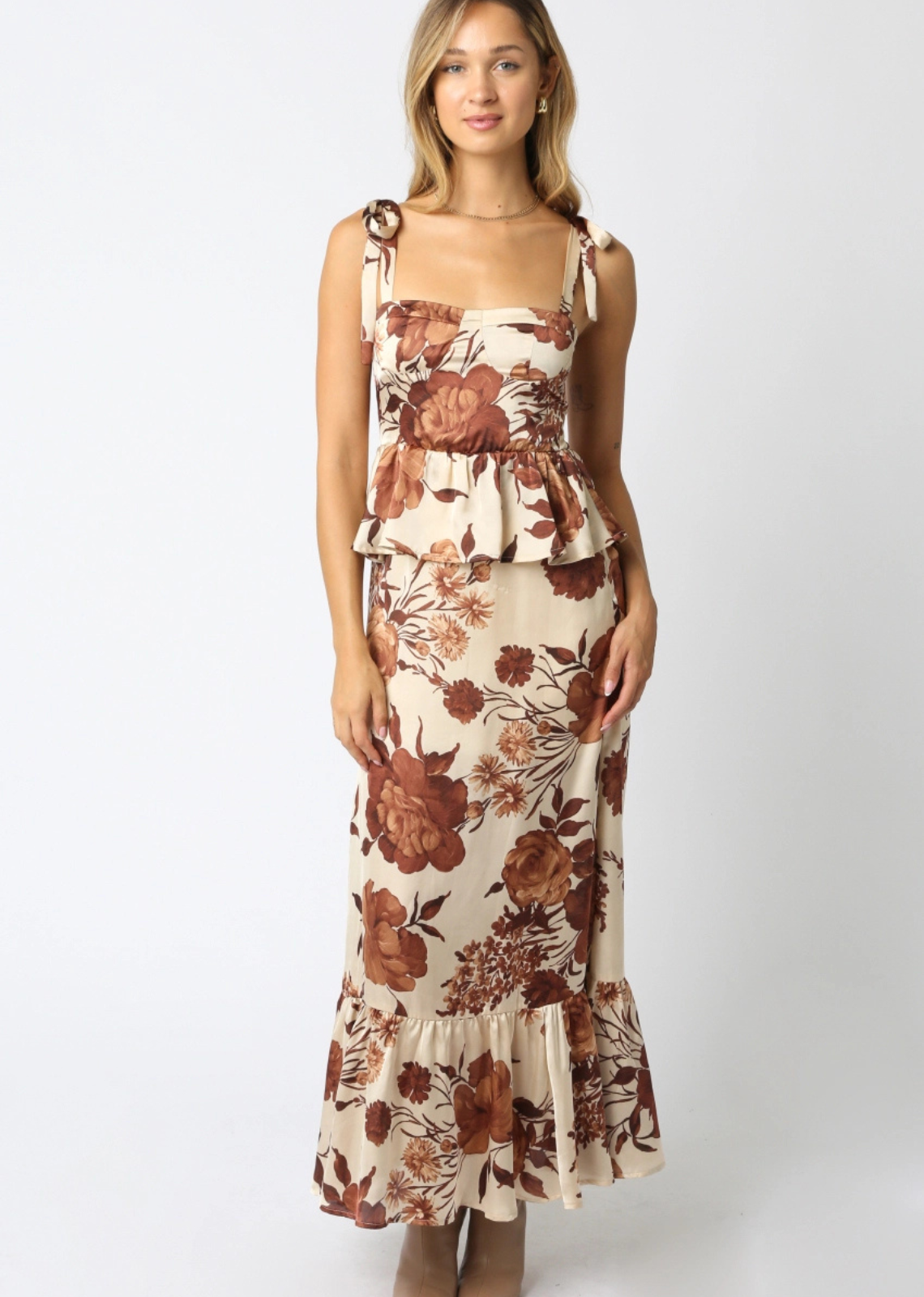 Woman wearing a floral dress on a white background. Shop at Lee & Me Boutique
