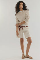 Tea coloured cotton knit sweater with a relaxed boxy fit, rolled neckline, dropped shoulders, and long sleeves.