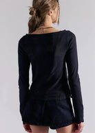 Deliah Long Sleeve top featuring a softly draped off-the-shoulder neckline, long fitted sleeves, and a flattering body-skimming silhouette with an elegant, feminine finish.
