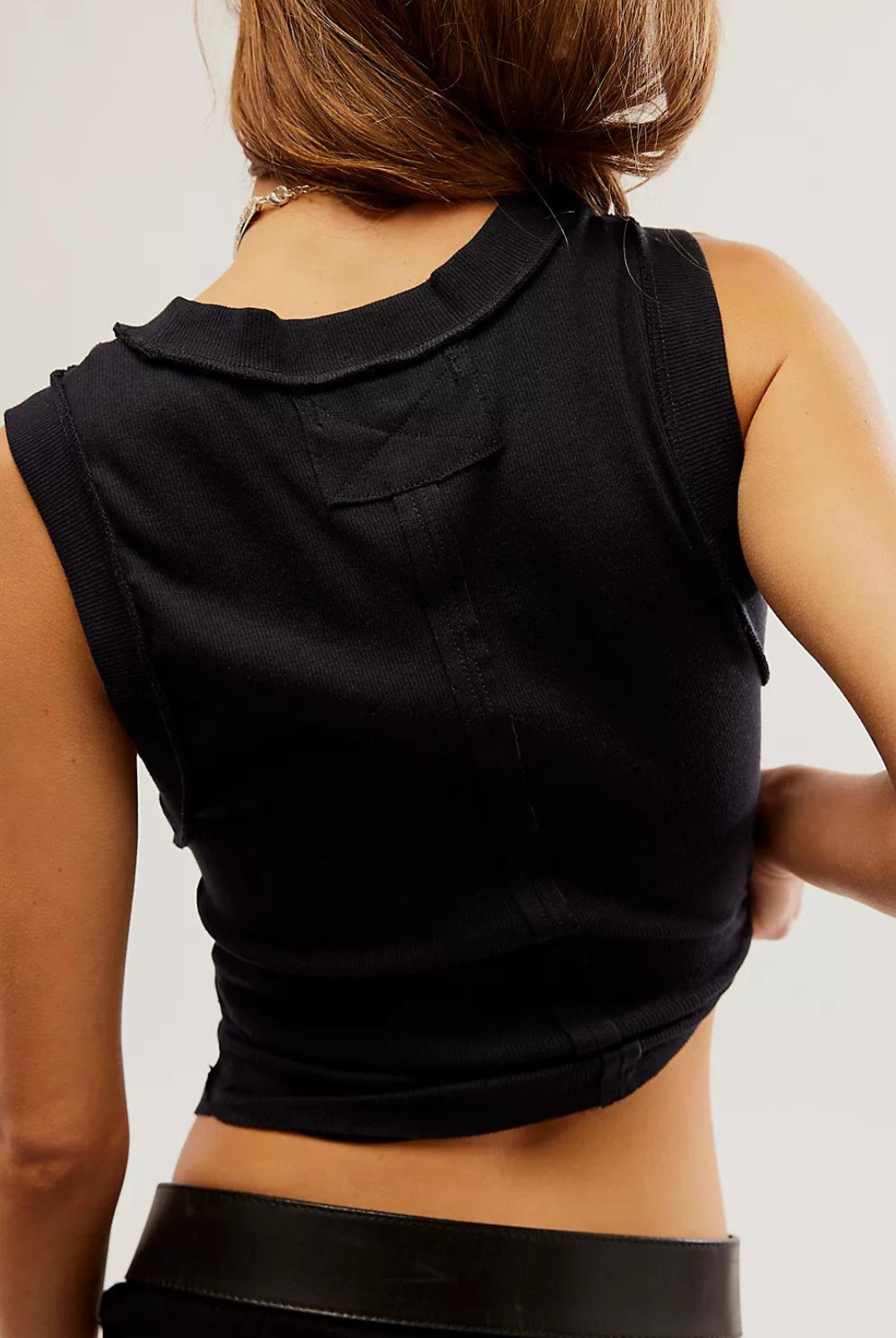 Free People Kate Tee- Black The ideal tank-inspired top, this sleeveless tee is featured in an effortless, goes-with-anything design with rounded bottom hem and exposed seaming for a true lived-in look.