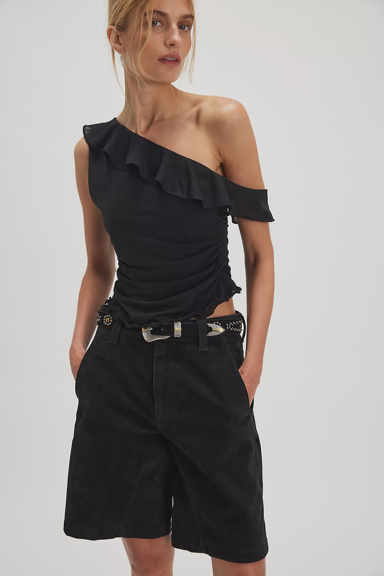 Woman wearing a black one-shoulder top 