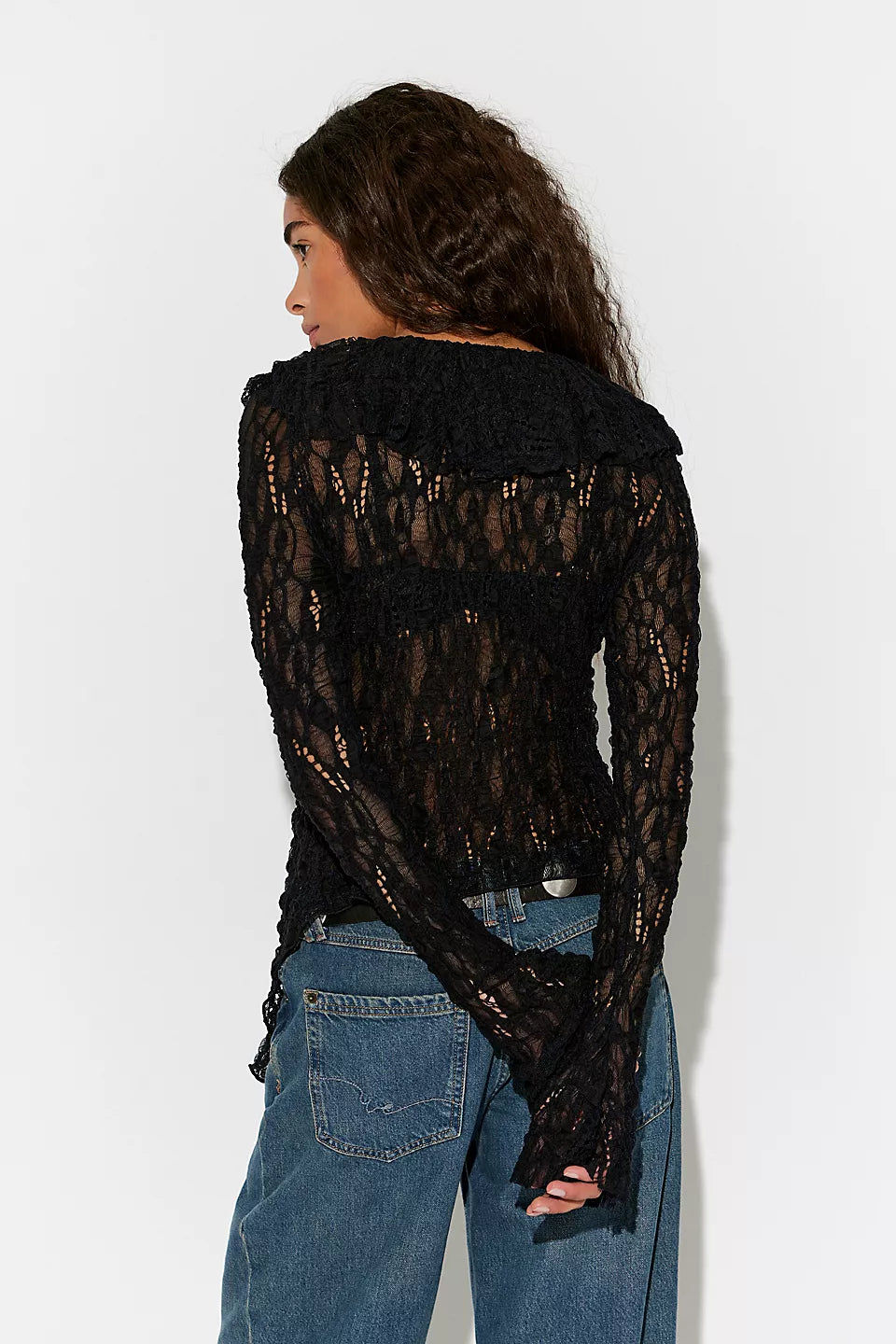 Textured lace cardigan in black, featuring a fitted longline silhouette, V-neckline, button-front closure, fitted long sleeves, and cascading ruffle hem detailing.