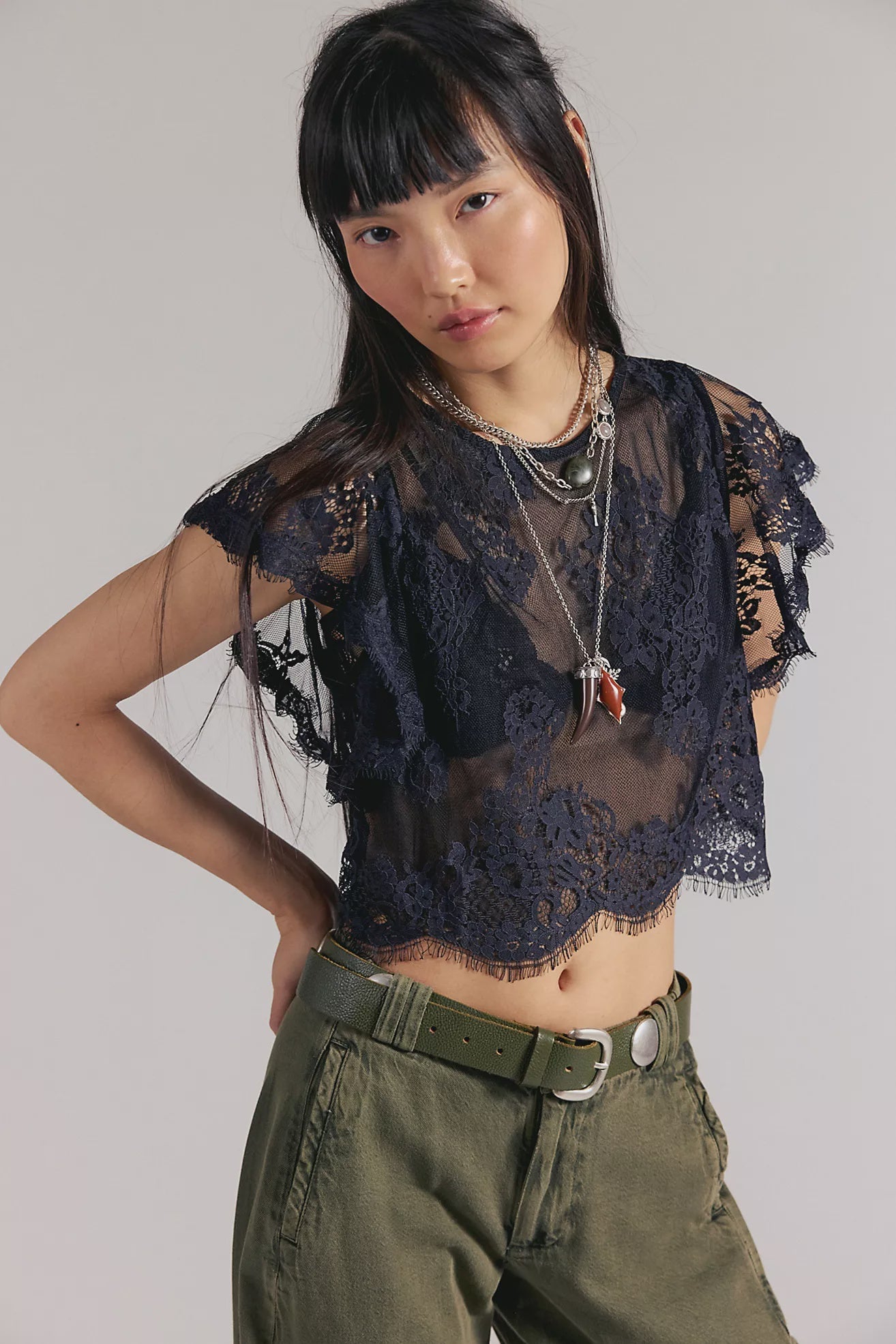 Woman wearing a black sheer lace top 