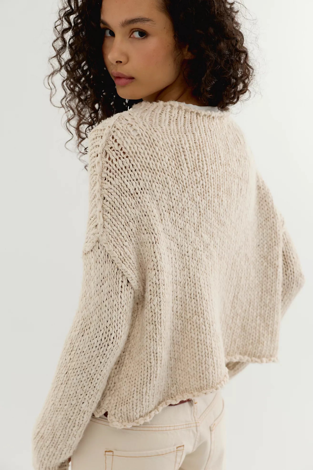 Tea coloured cotton knit sweater with a relaxed boxy fit, rolled neckline, dropped shoulders, and long sleeves.