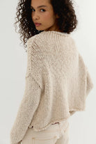 Tea coloured cotton knit sweater with a relaxed boxy fit, rolled neckline, dropped shoulders, and long sleeves.