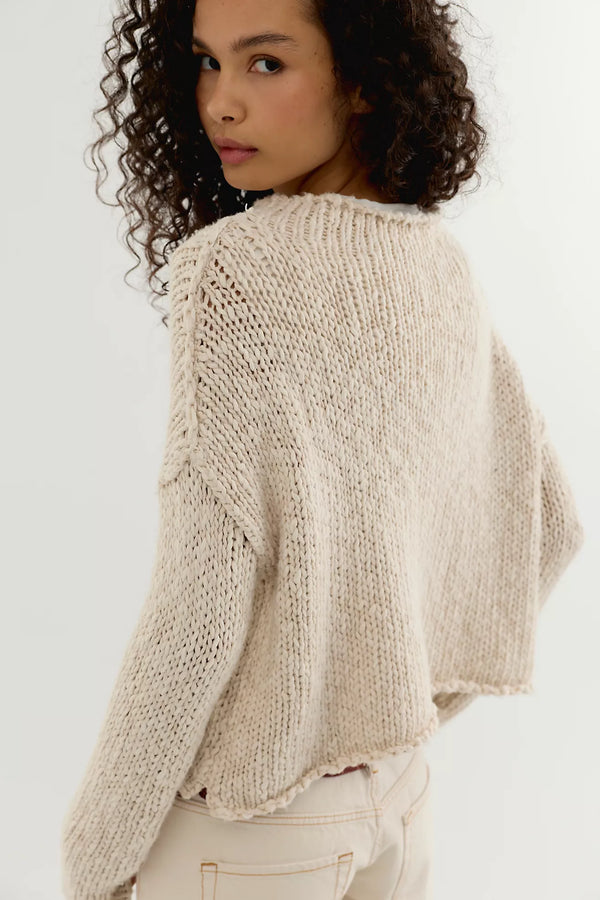 Tea coloured cotton knit sweater with a relaxed boxy fit, rolled neckline, dropped shoulders, and long sleeves.