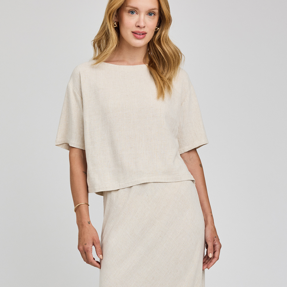 Woman wearing a beige outfit on a white background