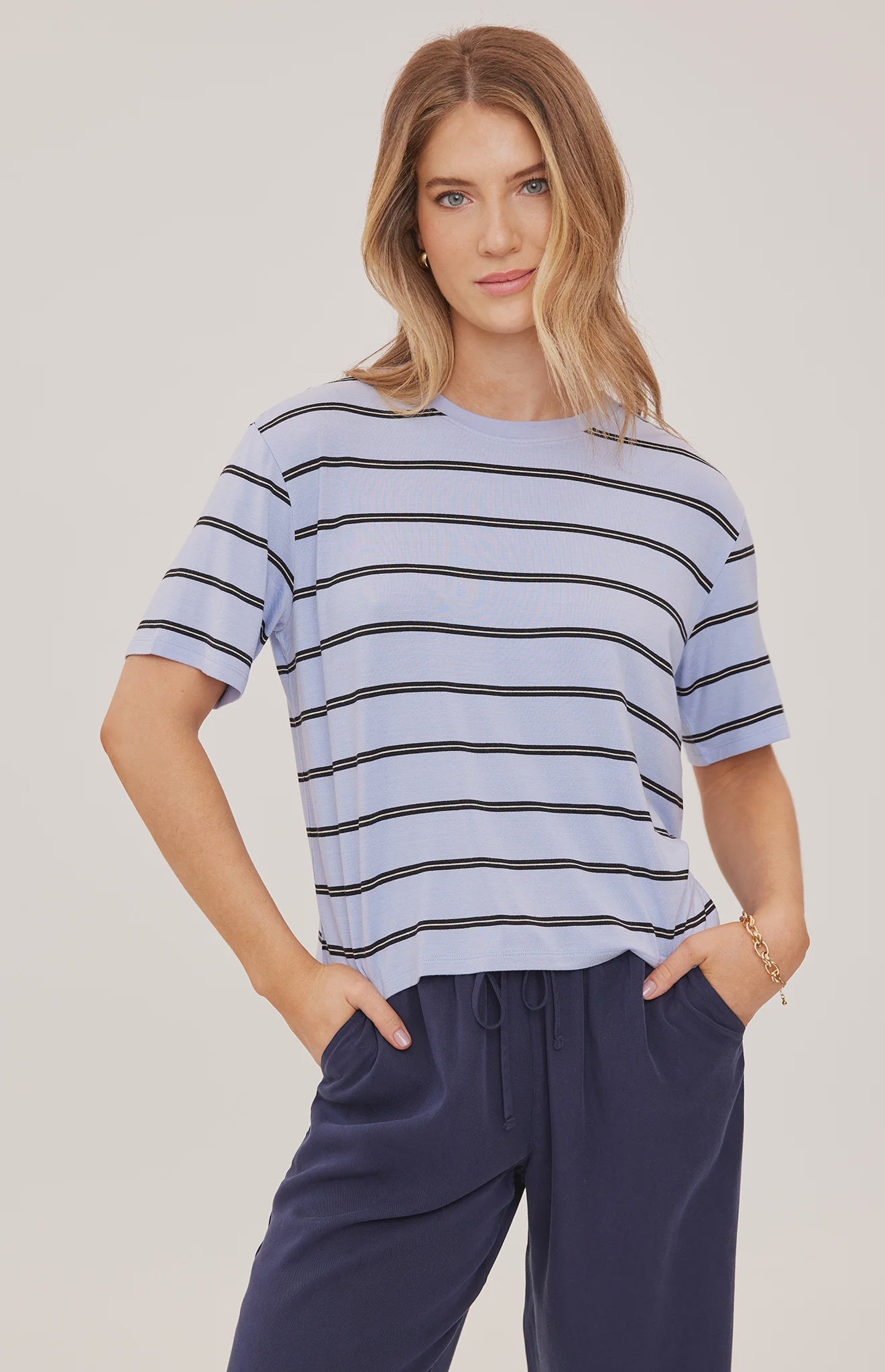 Women's relaxed oversized crewneck t-shirt featuring sky blue and white stripes, crafted from soft jersey knit with short sleeves and a comfortable oversized silhouette.