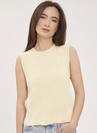 Woman wearing the Gentle Fawn Skylar Knit Tank in Parchment, featuring a soft lightweight knit, sleeveless silhouette, and classic neutral colour perfect for layering or wearing on its own.