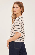Women's relaxed oversized crewneck t-shirt featuring cream and soft beige stripes, made from a lightweight jersey knit with short sleeves and an effortless everyday fit.