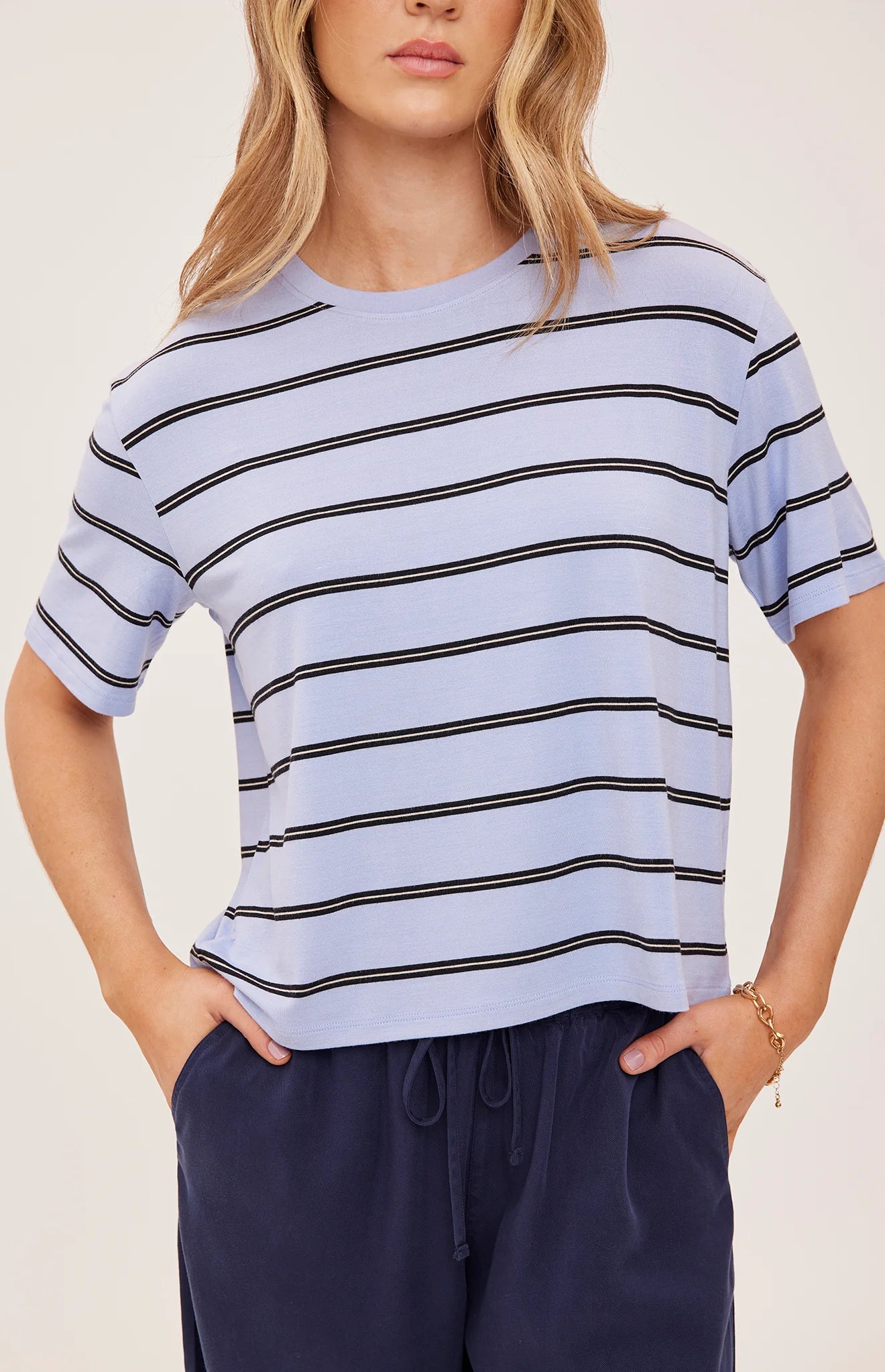 Women's relaxed oversized crewneck t-shirt featuring sky blue and white stripes, crafted from soft jersey knit with short sleeves and a comfortable oversized silhouette.