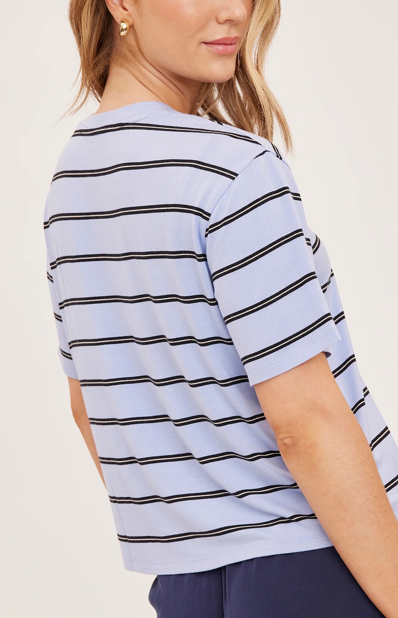 Women's relaxed oversized crewneck t-shirt featuring sky blue and white stripes, crafted from soft jersey knit with short sleeves and a comfortable oversized silhouette.