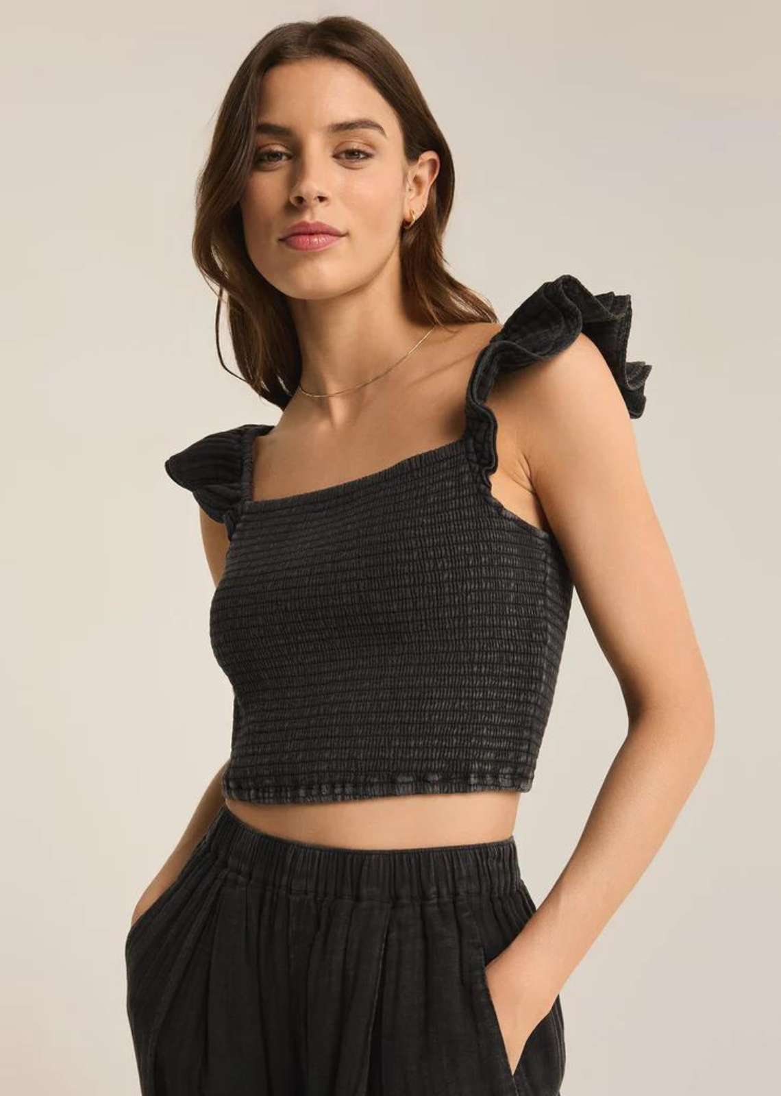 Step up your warm weather wardrobe with this flattering and fun crinkle cotton top. The ruffle cap sleeves are meant to drape off the shoulders for a romantic summery look.