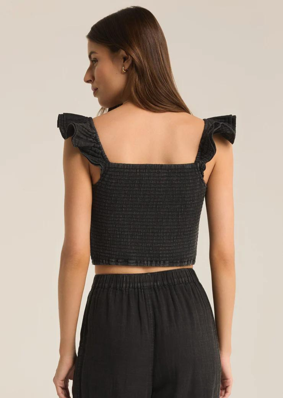 Step up your warm weather wardrobe with this flattering and fun crinkle cotton top. The ruffle cap sleeves are meant to drape off the shoulders for a romantic summery look.