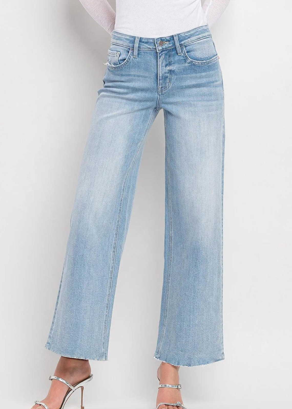 Vervet By Flying Monkey High Rise Wide Leg Jeans -Ben Rinnes. Crafted from comfort stretch denim, these jeans feature a high rise waist that flatters and a raw hem for a trendy touch. The full length and wide leg design offer both comfort and style, making these the perfect addition to any wardrobe.