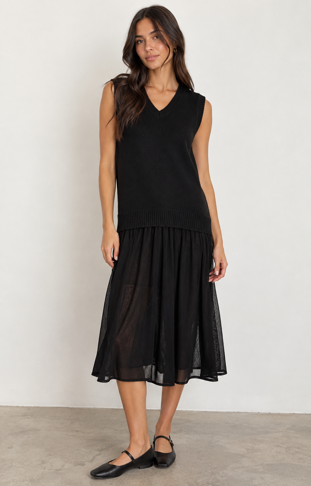 ICHI IHBANUS Dress in Black featuring a soft sleeveless knit bodice with a V-neckline, ribbed trim, and a lightweight sheer mesh midi skirt. Designed with a relaxed silhouette and contrasting textures for an effortlessly chic, feminine look.