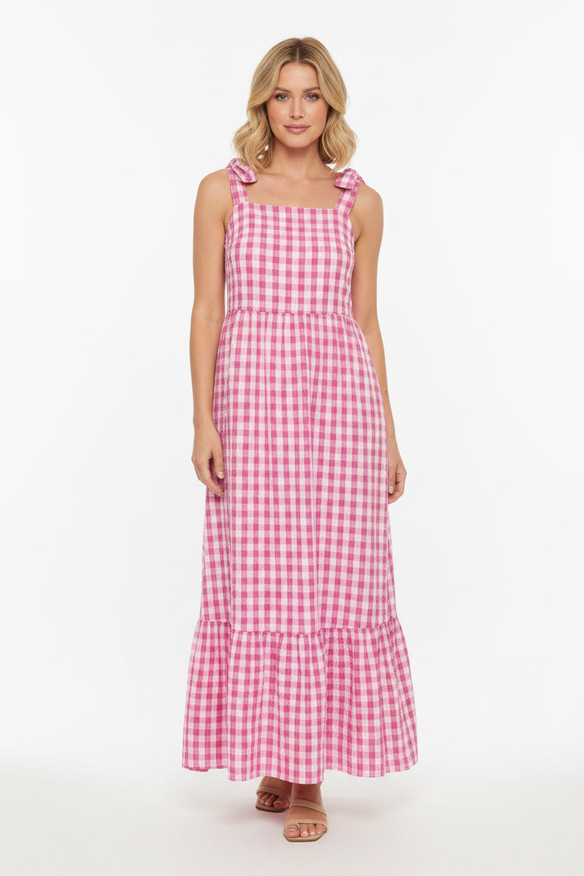 Pink and white checkered dress with bow straps on a white background