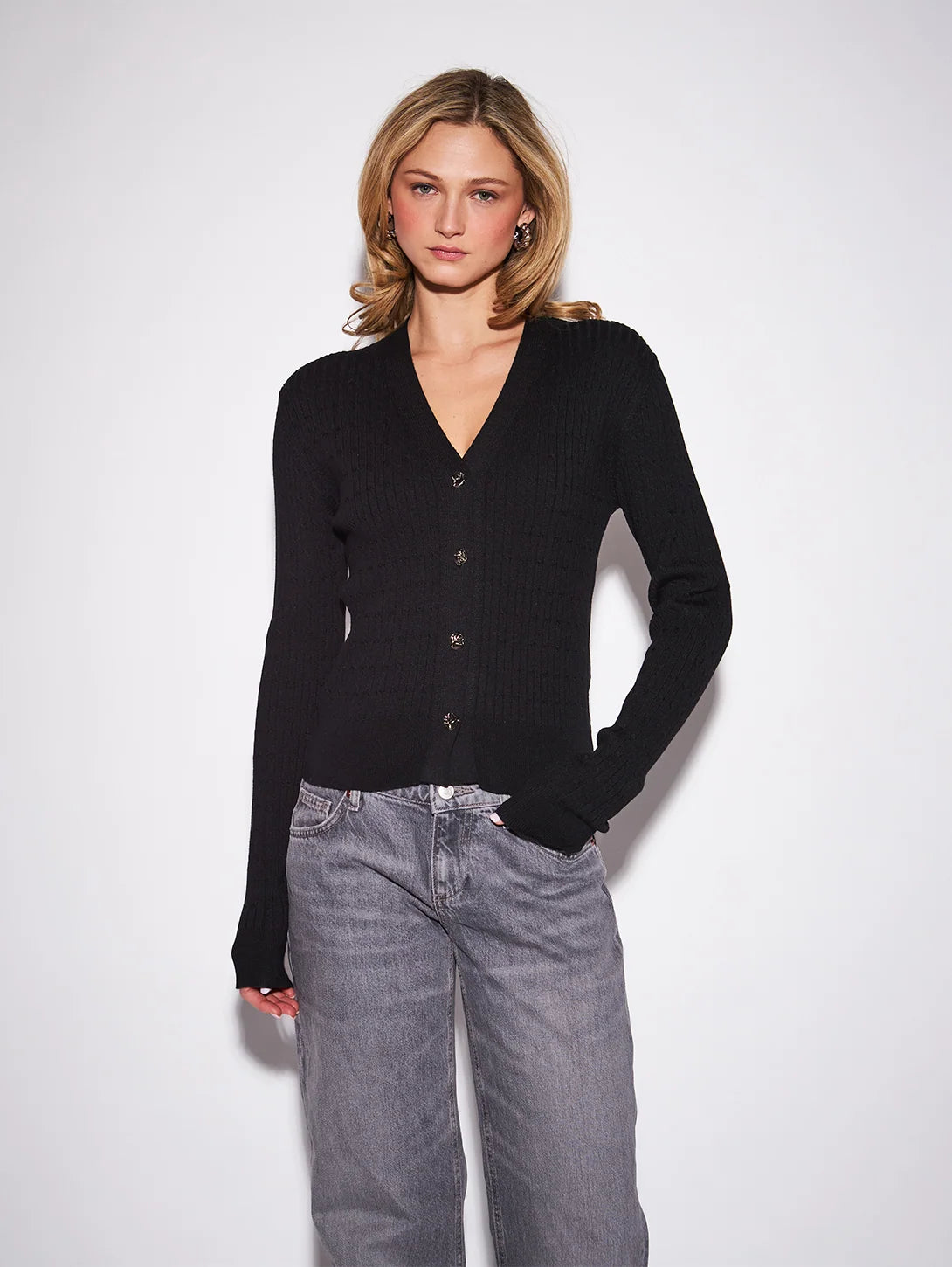 John & Jenn Maura Cardigan featuring a flattering V-neckline, delicate button-front closure, long sleeves, and a relaxed silhouette in a soft knit fabric for a polished, feminine look.