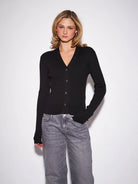 John & Jenn Maura Cardigan featuring a flattering V-neckline, delicate button-front closure, long sleeves, and a relaxed silhouette in a soft knit fabric for a polished, feminine look.