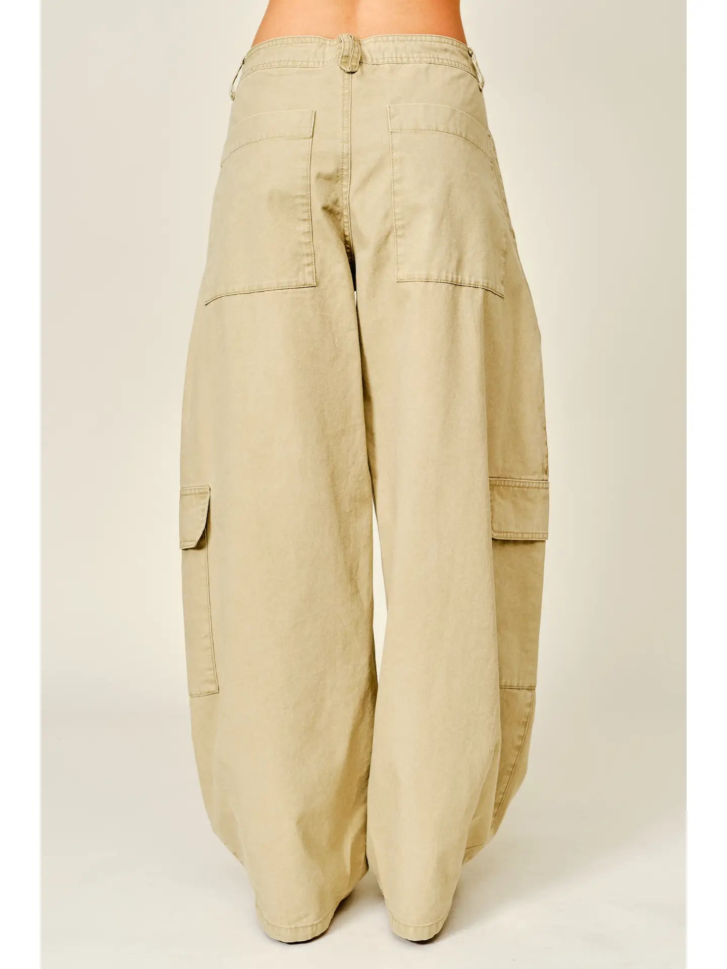 Relaxed barrel-leg pants featuring an adjustable waist tie and functional side pockets, designed in a lightweight fabric for a comfortable, versatile fit.