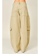Relaxed barrel-leg pants featuring an adjustable waist tie and functional side pockets, designed in a lightweight fabric for a comfortable, versatile fit.