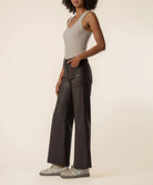 Coated wide-leg jeans featuring a sleek finish, Fab Ab front pockets, ankle-grazing length, and raw wide hems for a modern silhouette.