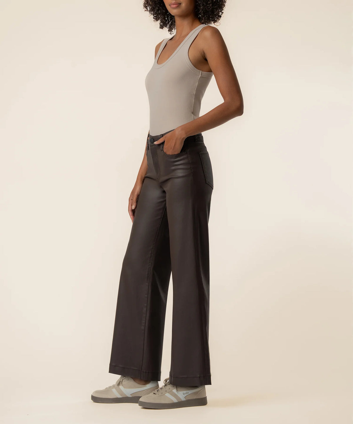Coated wide-leg jeans featuring a sleek finish, Fab Ab front pockets, ankle-grazing length, and raw wide hems for a modern silhouette.