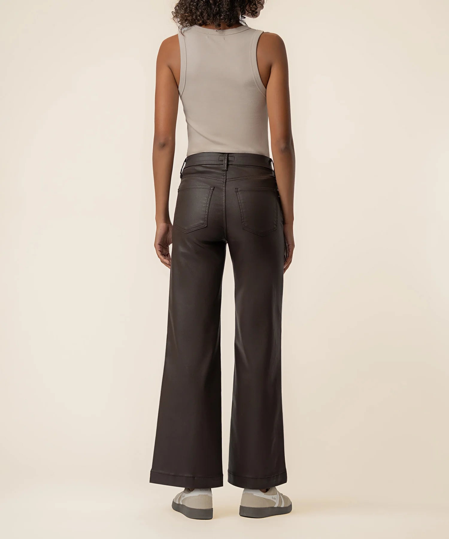 Coated wide-leg jeans featuring a sleek finish, Fab Ab front pockets, ankle-grazing length, and raw wide hems for a modern silhouette.